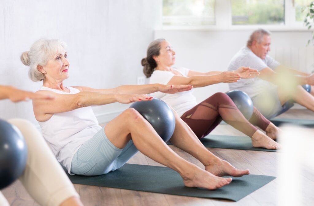a group of seniors taking a pilates class to stay active