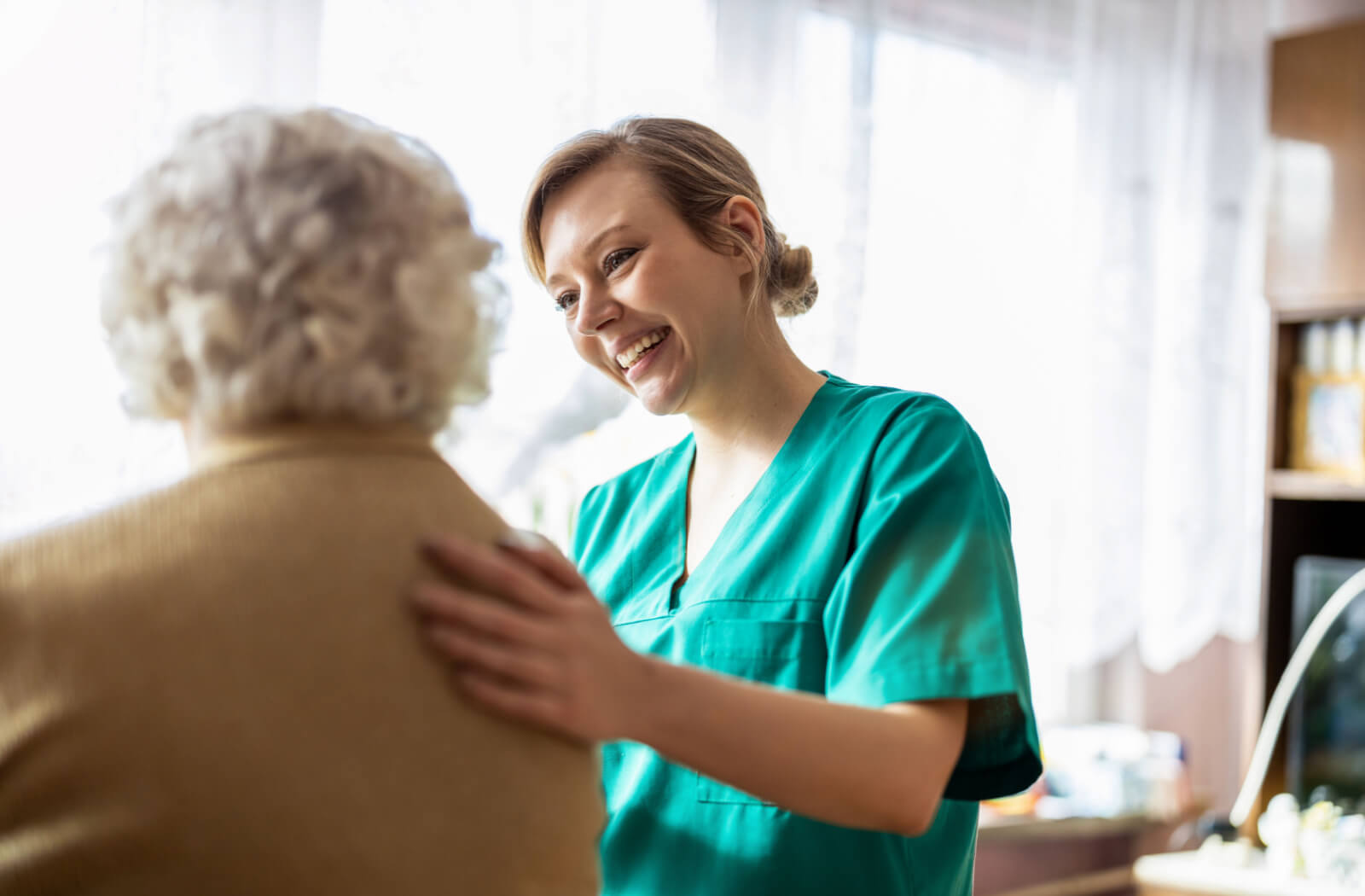 A nurse talking to one of the the community members in a skilled nursing community.