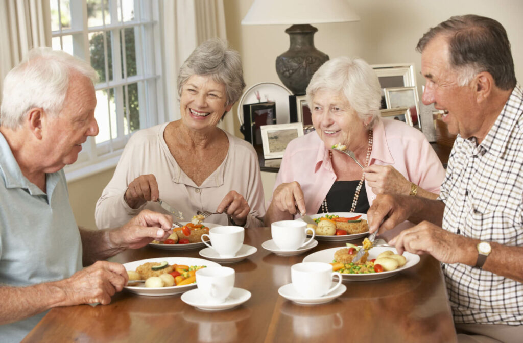 A group of happy seniors eating lunch together.