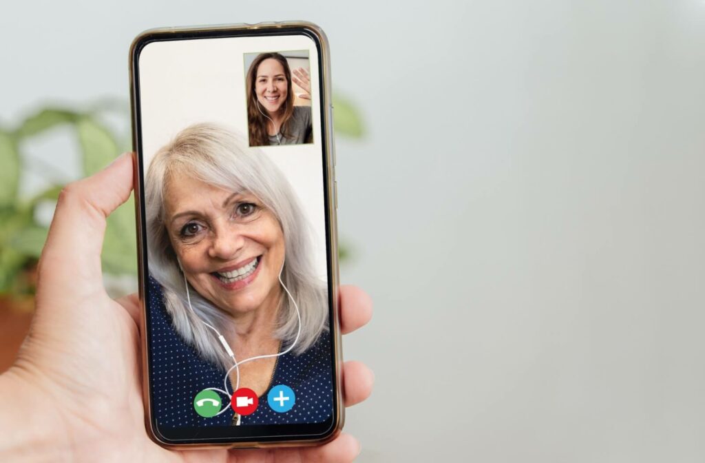 An adult accepts a video call from their older parent on their phone to help them stay socially active for their memory